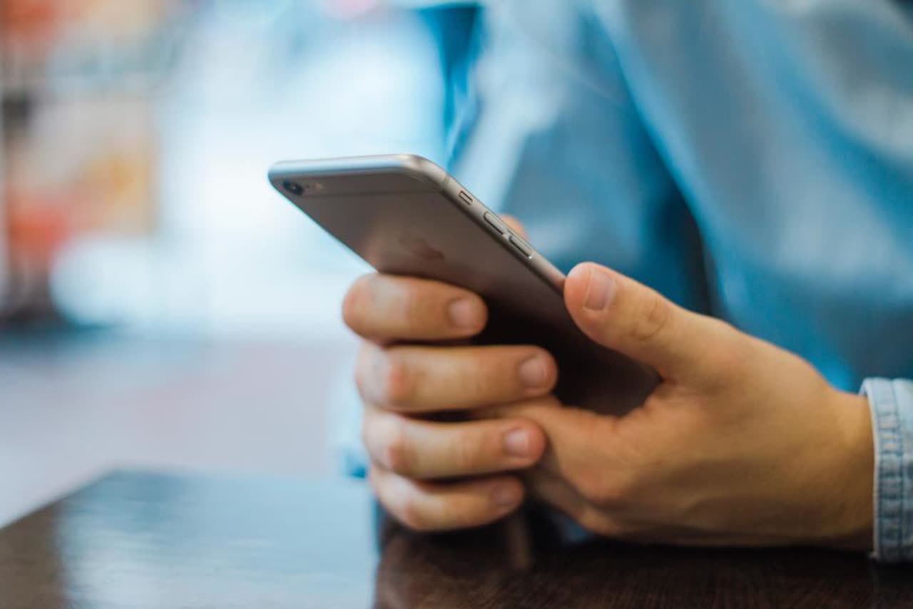 Close-up of a person using their phone to confirm a code